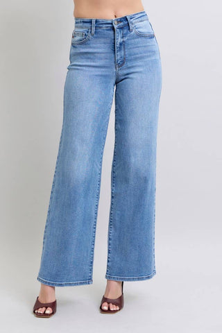 Light blue jeans worn by a person on a plain background