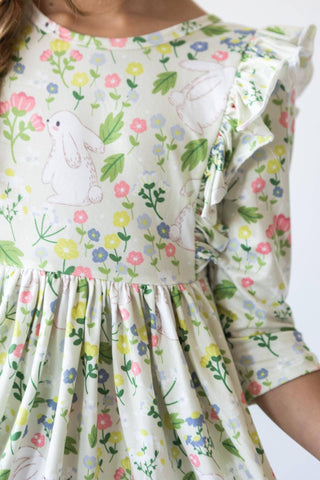 Girl wearing No Bunny Like You 3/4 sleeve ruffle twirl dress from JSQ Mercantile – a women’s boutique and gift shop in La Grange, IL.