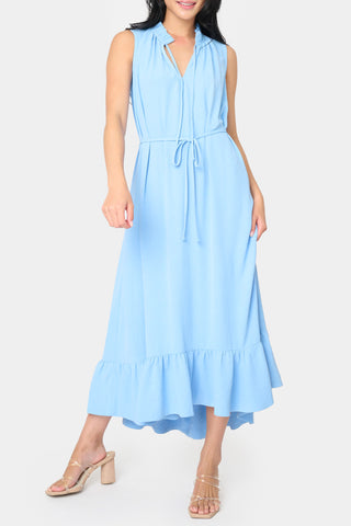Sky blue sleeveless midi dress with split tie neckline, tie waist, oversized ruffle hem, and hi-low silhouette, styled for a special occasion – JSQ Mercantile – a women’s boutique and gift shop in La Grange, IL