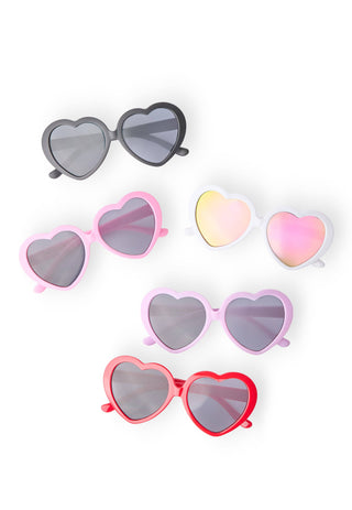 Girl wearing heart shaped sunglasses from JSQ Mercantile – a women’s boutique and gift shop in La Grange, IL.