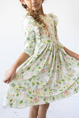 Girl wearing No Bunny Like You 3/4 sleeve ruffle twirl dress from JSQ Mercantile – a women’s boutique and gift shop in La Grange, IL.