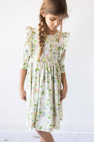 Girl wearing No Bunny Like You 3/4 sleeve ruffle twirl dress from JSQ Mercantile – a women’s boutique and gift shop in La Grange, IL.